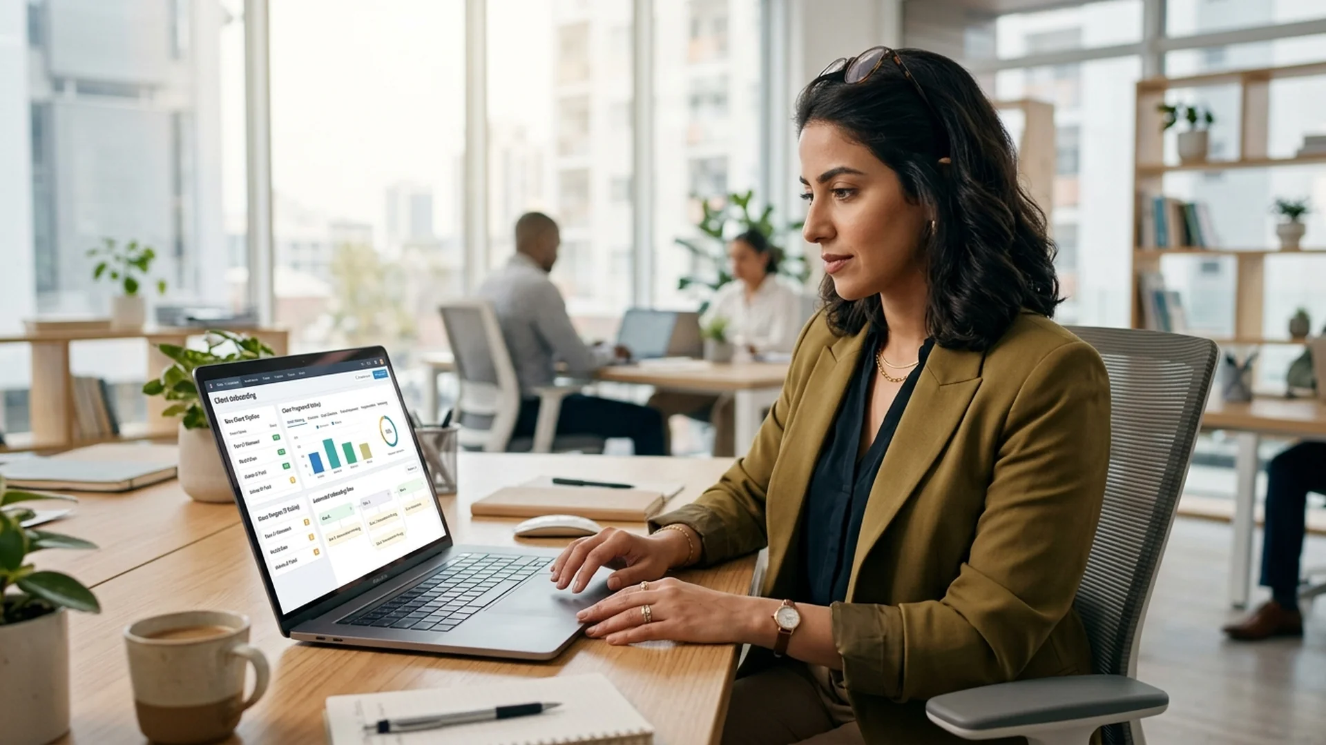 A financial advisor sitting at a desk looking at a computer screen showing a CRM dash — financial services